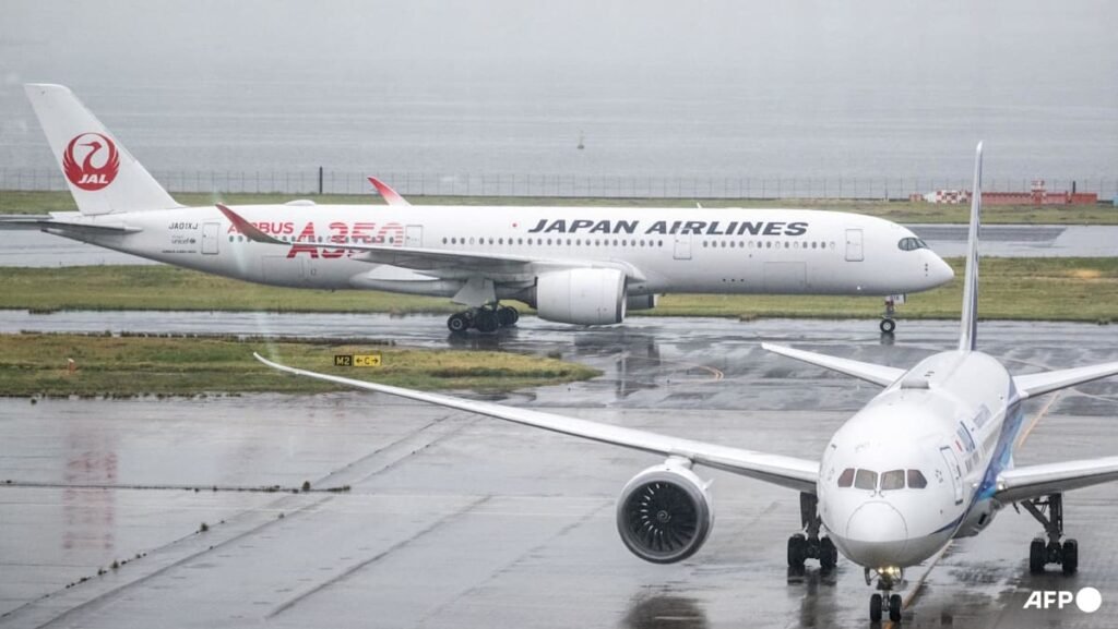 Japan cancels 100 flights as twin storms approach