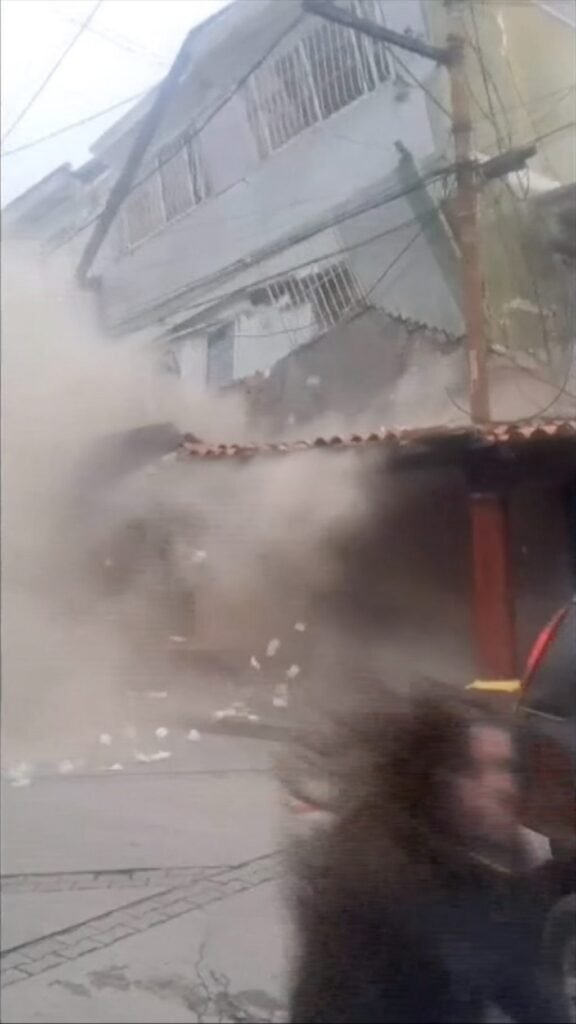 People flee as building collapses on the outskirts of Caracas