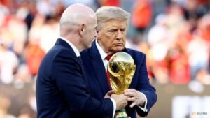 Trump lingers on stage to lap up World Cup spotlight