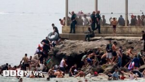 Hundreds of migrants swim from Morocco to Spanish enclave of Ceuta