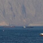 Oil drops, stocks hit records on hopes of Hormuz opening