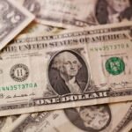Dollar higher after Iran sanctions, loonie drops after US announces tariff increases