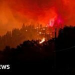 Fast-moving Canada wildfire doubles in size forcing thousands to flee homes