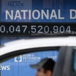 How does the US national debt affect consumers around the world?