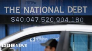 How does the US national debt affect consumers around the world?
