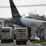 Amazon cargo plane overshoots Miami runway, hits vehicles, catches fire