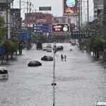 Heavy rain and flooding in Bangkok disrupts traffic and prompts evacuations