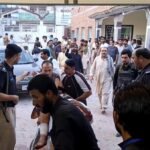 Gunmen target ambulance in Pakistan after suicide bombing at checkpoint killed 12