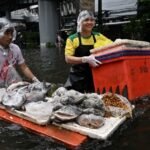 In kayaks or waist-deep in floodwater, shoppers return to Bangkok markets