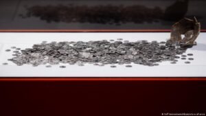 Amateur archeologist unearths Germany’s largest trove of Roman coins