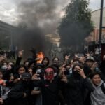 French school protests spread as fires, blockades deepen unrest