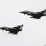 Ukraine apologizes after a suspected drone crashes in Lithuania, damaging a moving car.