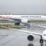 Japan cancels 100 flights as twin storms approach