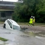 Video. Woman rescued after car plunges into flooded sinkhole