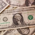 Dollar retreats as US inflation data eases rate hike expectations