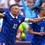 Mbappe double sends France into World Cup knockout rounds after weather delay