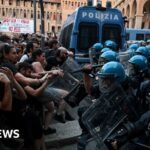 Italy protests: Dozens hurt in Bologna after man dies while being restrained by police