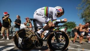 Evenepoel wins time trial to cut Pogacar’s lead