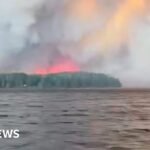 Watch: Residents flee massive Canadian wildfire by boat