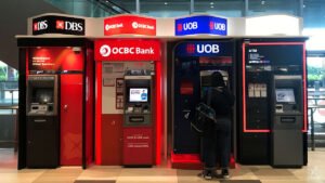 Singapore bank stocks are at record highs. Should you buy, hold or sell?