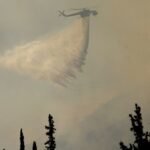 Firefighters in Greece struggle to save coastal resort as winds rage