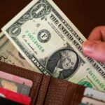 Dollar edges higher as investors weigh Iran sanctions, Treasury buybacks