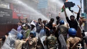 Indian police use water cannon at new protest over test paper leaks