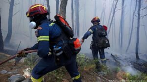Greek firefighters struggle to save coastal resort