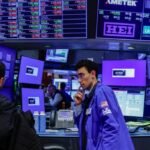 Stocks slip as dollar heads for weekly loss