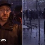 Fireworks and tear gas as protesters and riot police clash in Paris