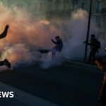 Clashes erupt between police and protesters in Paris