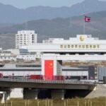 Trucks line up as long-delayed China-North Korea bridge officially opens