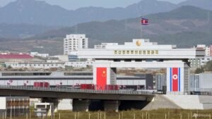 Trucks line up as long-delayed China-North Korea bridge officially opens