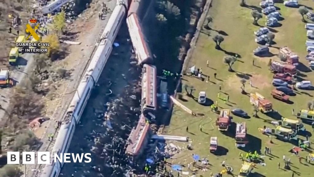Overturned carriages and makeshift medical tents at Spain train crash site